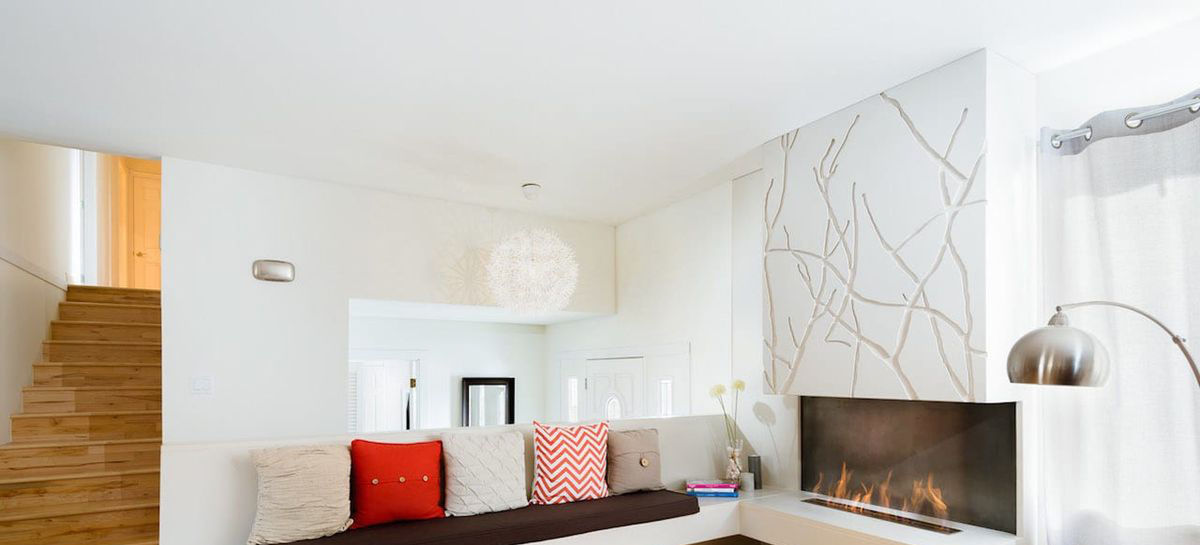 A concrete fireplace effortlessly creates atmosphere in this modern living room.