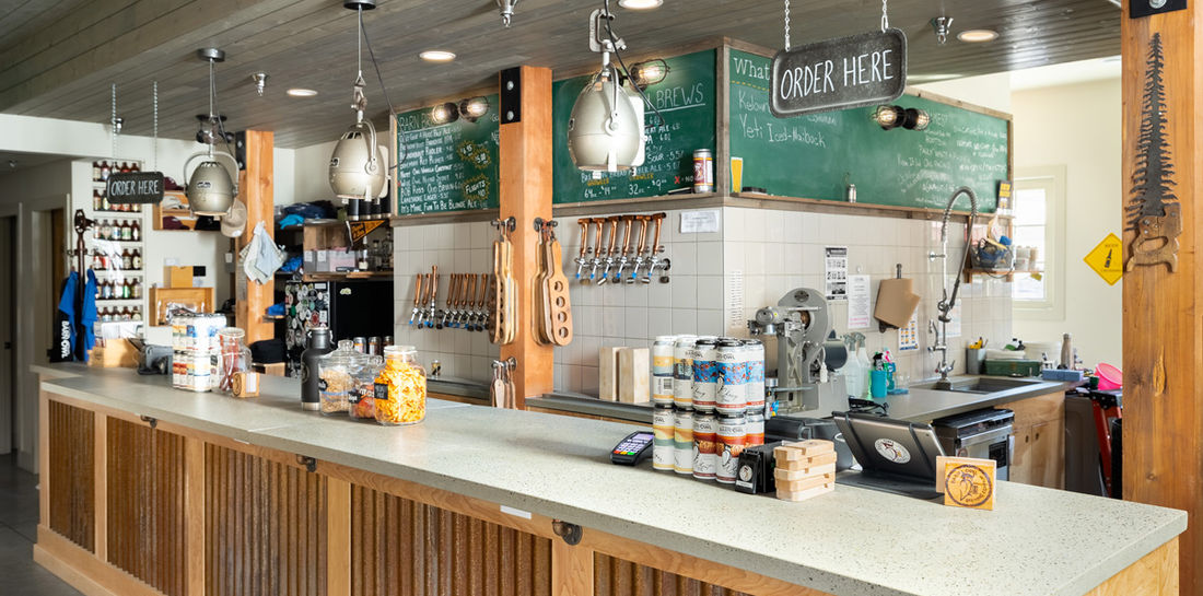 A sleekly designed custom concrete counter adds to the atmosphere at Kelowna’s Barn Owl Brewery, a local craft brewing company.