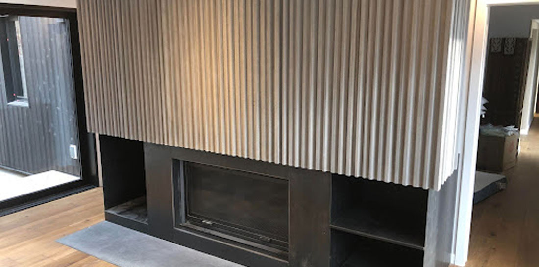 A custom concrete fireplace is the centrepiece of this modern living room. 