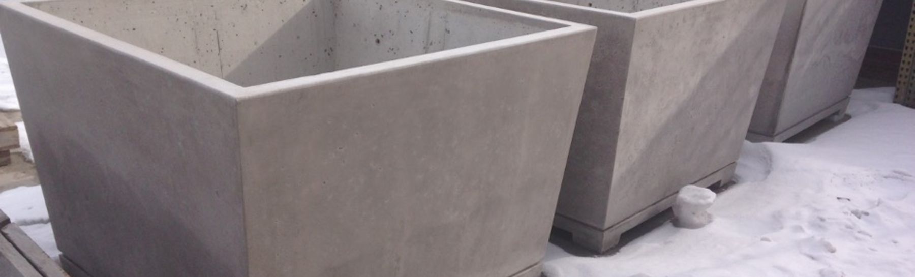 Precast concrete planters that are a result of collaboration between Bench Site Design and Versatile Concrete. 
